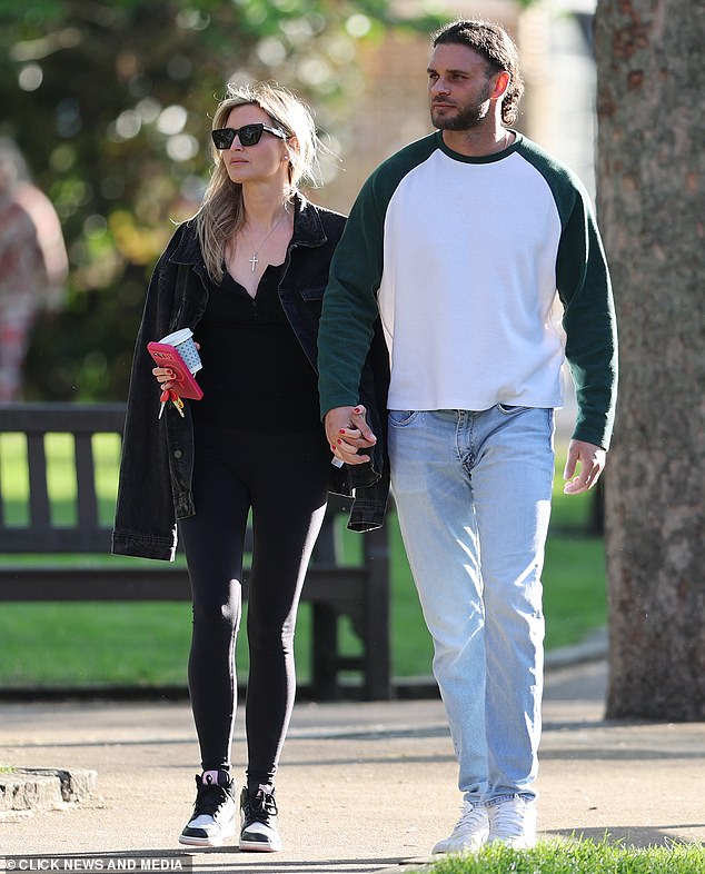 The pair were snapped walking through a sunny London park while holding hands