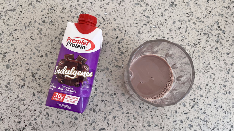 Indulgence Decadent Dark Chocolate bottle and a glass cup