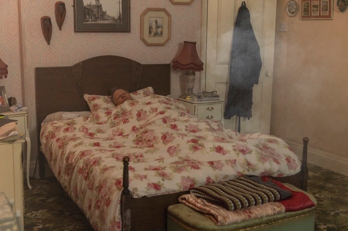Smoke echoes around Roy Cropper's bedroom as he sleeps in a scene from Coronation Street