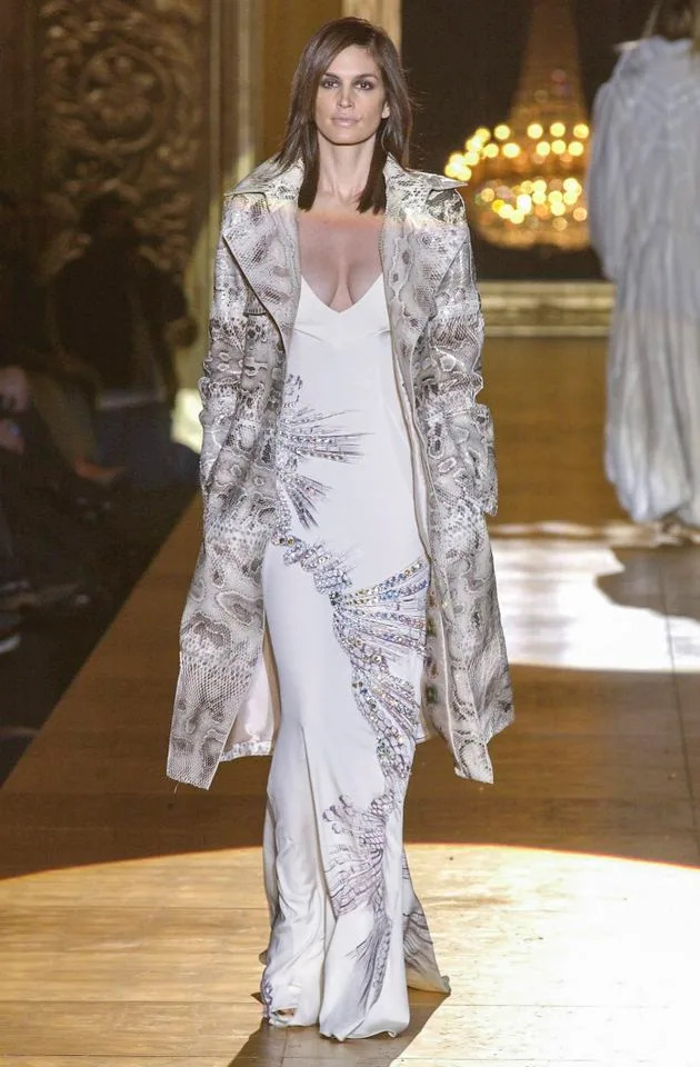 Cindy Crawford walks the runway during the Roberto Cavalli Ready to Wear Fall/Winter 2002-2003 show during Milan Fashion Week.Credit: Getty