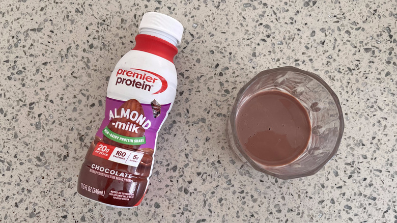 Almond Milk Chocolate bottle with a glass cup