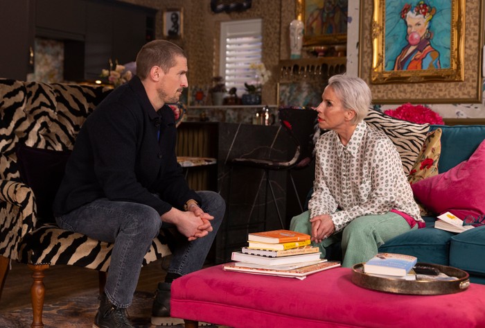 Debbie chats to Carl in her living room in a scene from Coronation Street