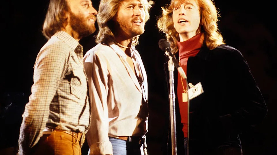 Maurice Gibb, Barry Gibb and Robin Gibb of The Bee Gees harmonise at one microphone while performing on stage on January 9, 1979 in New York. Richard E&period; Aaron&sol;Redferns