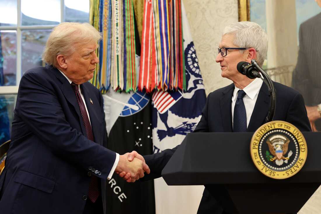 Apple CEO Tim Cook shakes hands with President Trump during an event in the White House's Oval Office on August 6, 2025.