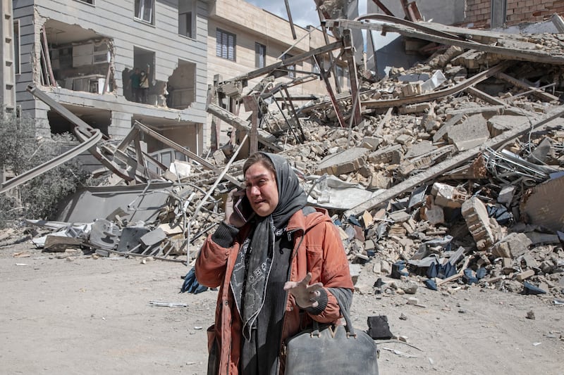 A resident weeps while talking on the phone near a residential building that was hit in an air strike in Tehran, Iran. Photograph: Majid Saeedi/Getty Images