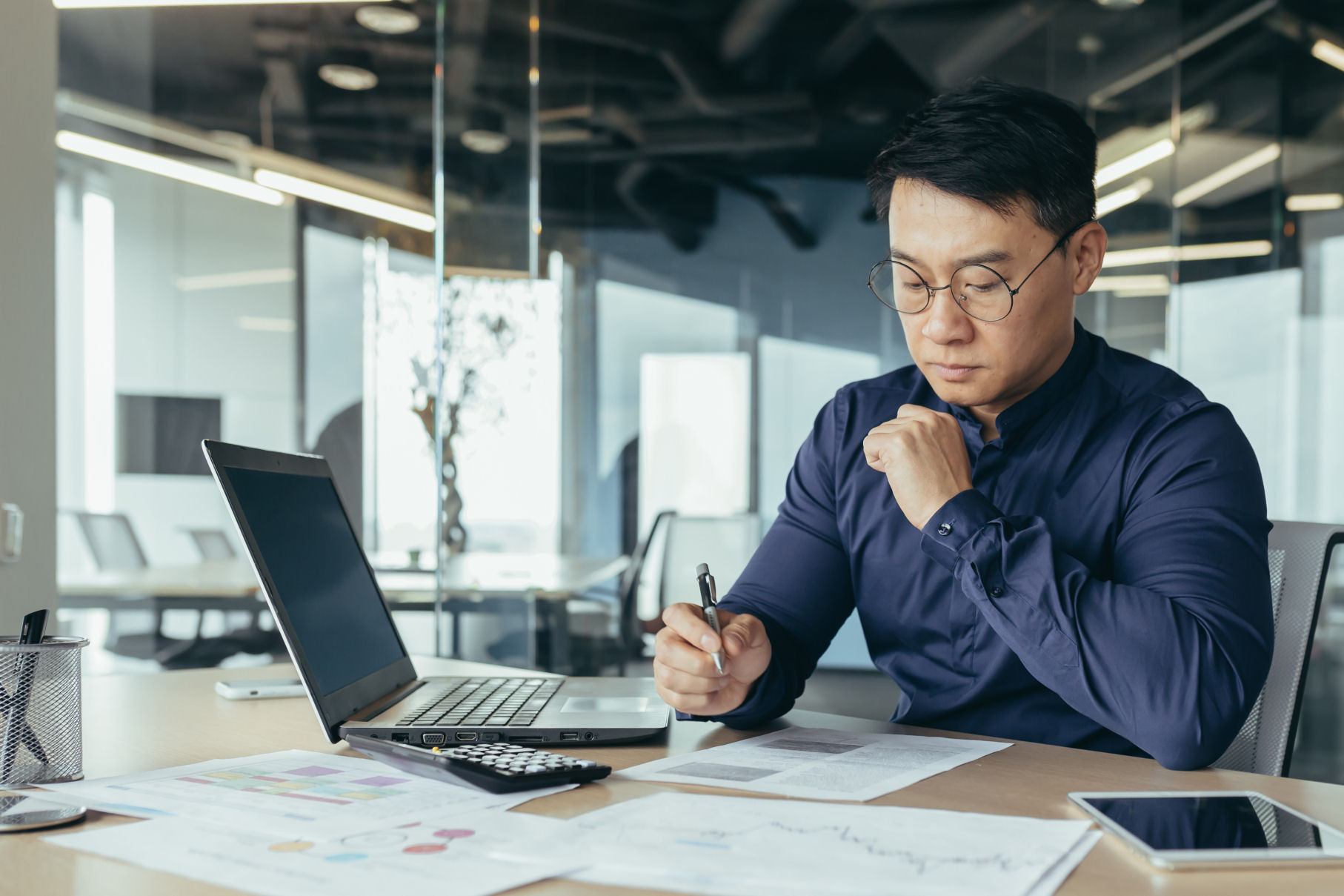 A person sitting at a desk, taking notes.
