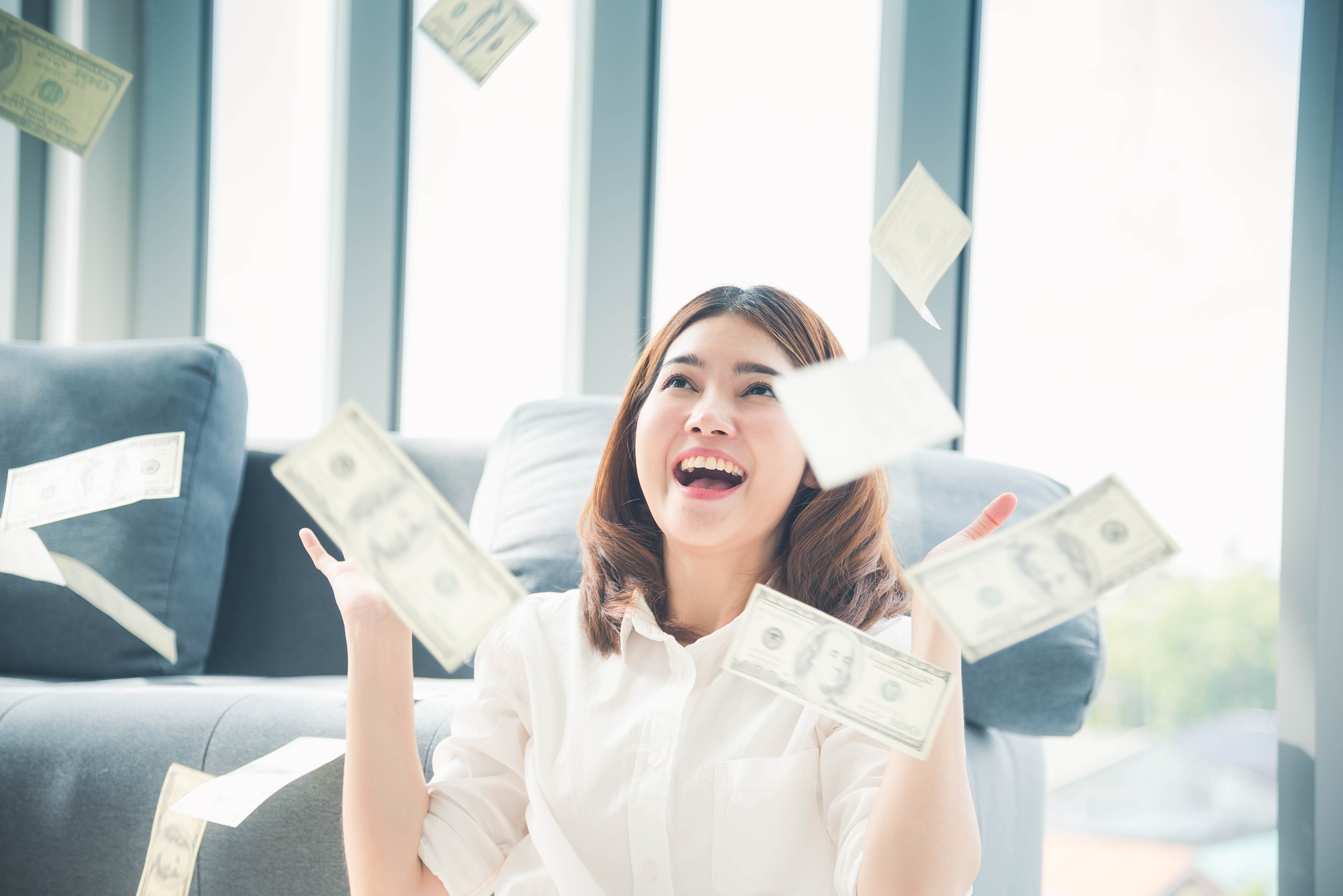 Person throwing money in the air.
