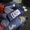 A person tries to use the CBP One app on their phone.