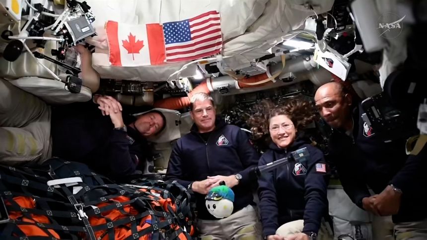 (From left) Artemis II's Reid Wiseman, Jeremy Hansen, Christina Koch, and Victor Glover take interviews from the Orion capsule in outer space.