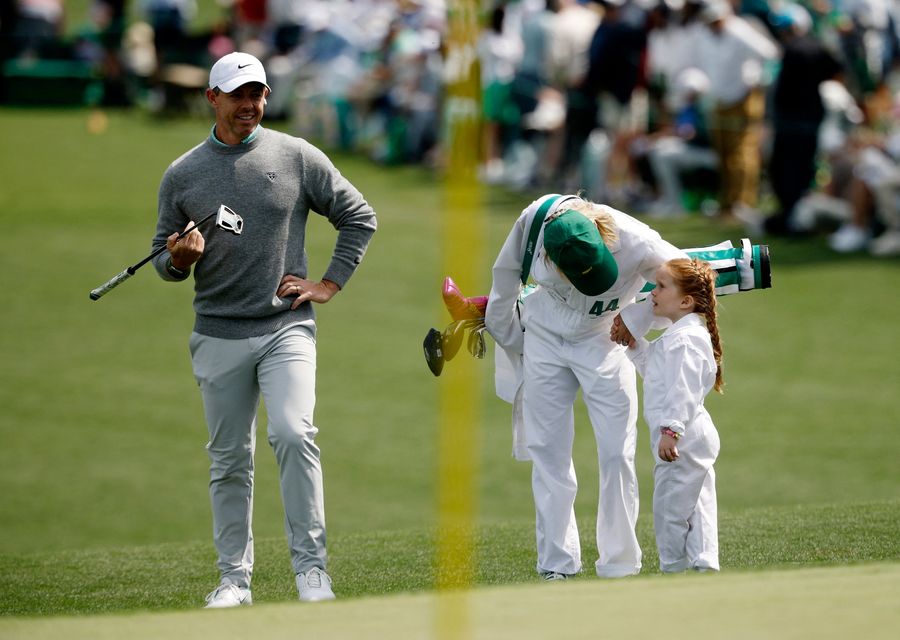 Golf - The Masters - Augusta National Golf Club, Augusta, Georgia, U.S. - April 8, 2026
Northern Ireland's Rory McIlroy with Ireland's Shane Lowry's wife Wendy Lowry and daughter Iris Lowry on the green of the 2nd hole during the par 3 contest REUTERS/Brian Snyder