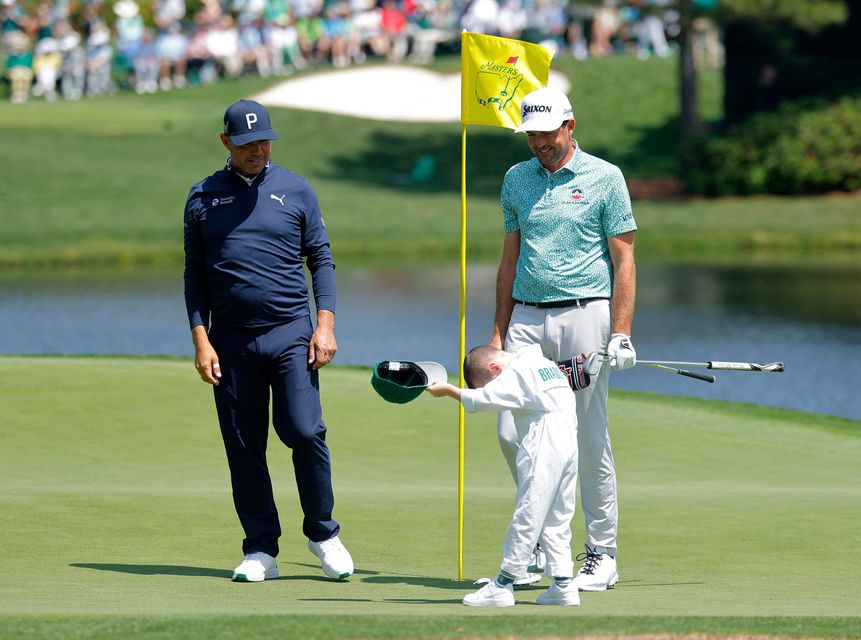 Golf - The Masters - Augusta National Golf Club, Augusta, Georgia, U.S. - April 8, 2026
Keegan Bradley of the U.S. with his son and Gary Woodland of the U.S. on the 6th hole during the par 3 contest REUTERS/Mike Blake