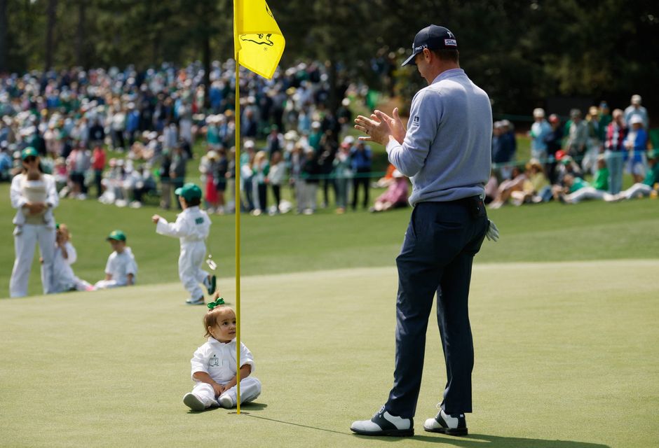Golf - The Masters - Augusta National Golf Club, Augusta, Georgia, U.S. - April 8, 2026
Justin Thomas of the U.S. with his daughter Molly Thomas on the green of the 2nd hole during the par 3 contest REUTERS/Brian Snyder