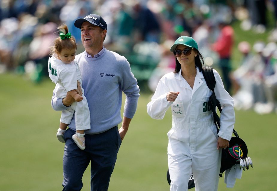 Golf - The Masters - Augusta National Golf Club, Augusta, Georgia, U.S. - April 8, 2026
Justin Thomas of the U.S. with his wife Jillian Wisniewski and daughter Molly Thomas on the 2nd hole during the par 3 contest REUTERS/Brian Snyder
