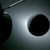 The moon, seen here backlit by the sun during a solar eclipse on Monday, is photographed by one of the cameras on the Orion spacecraft’s solar array wings