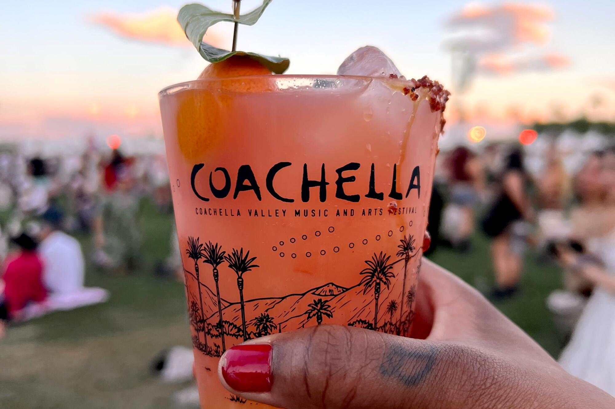 An orange cocktail with a kumquat.