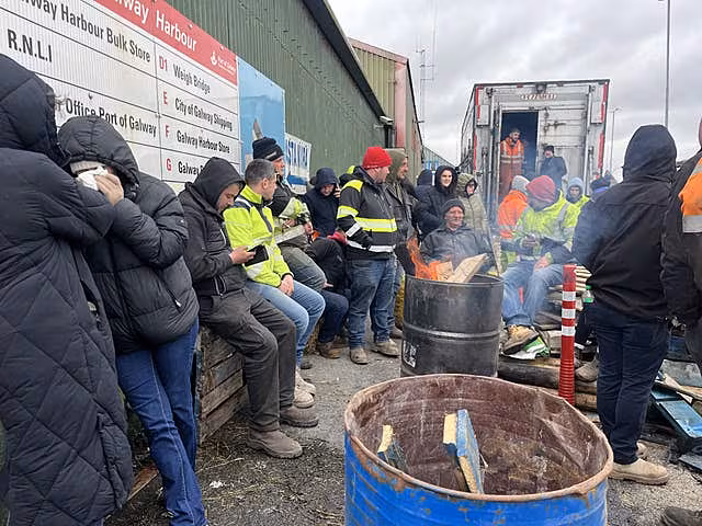 Protesters gathered round a fire in a barrel