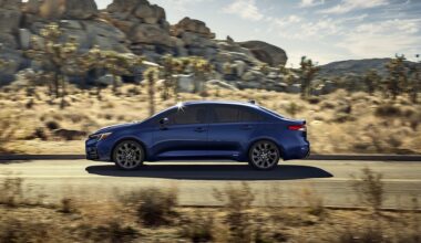 2025 Toyota Corolla Hybrid driving on a desert road for promotional photo.