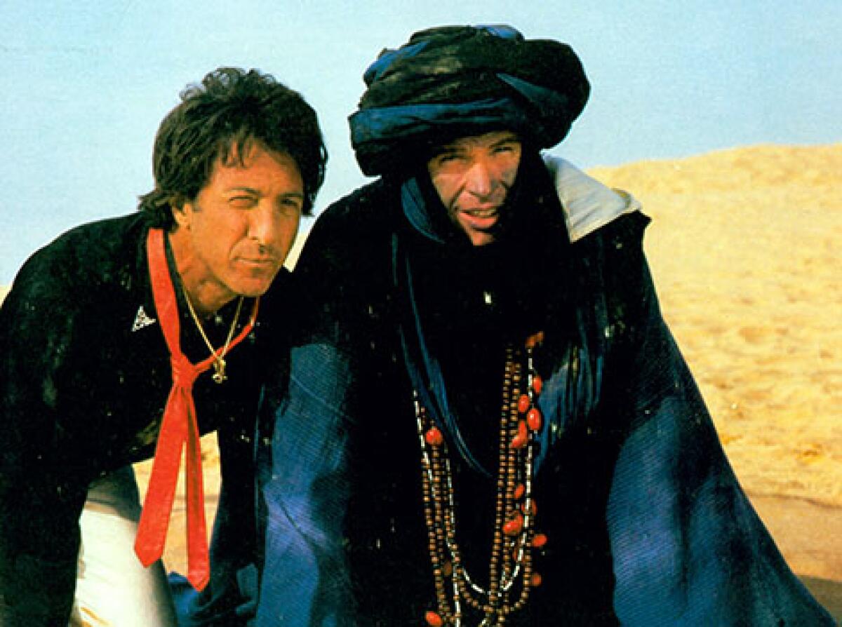 Two men hide in the desert.