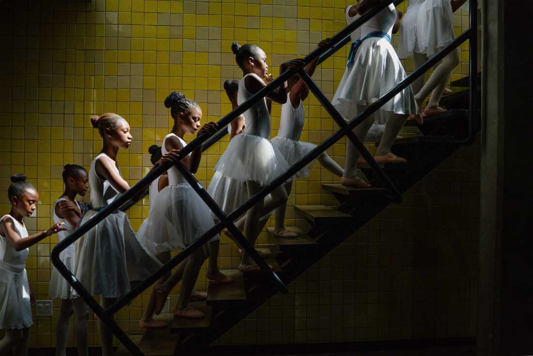 Title: Joburg Ballet School Credit: © Ihsaan Haffejee, for GroundUp Caption: Young dancers from the Joburg Ballet School backstage at the Soweto Theatre during their year-end performance. Soweto, South Africa, 7 December 2025. Story: In apartheid South Africa, ballet was the preserve of white culture, inaccessible to people of color. Today, the Joburg Ballet School offers subsidized training to children from historically disadvantaged backgrounds, with locations in Soweto, Alexandra, and Braamfontein. Parents describe seeing their children learn ballet as something they never thought possible.