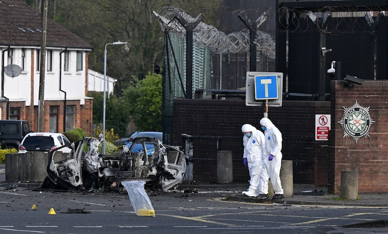 Forensic officers gather evidence at the scene of a reported car explosion near Dunmurry police station. Photograph: Charles McQuillan/Getty Images