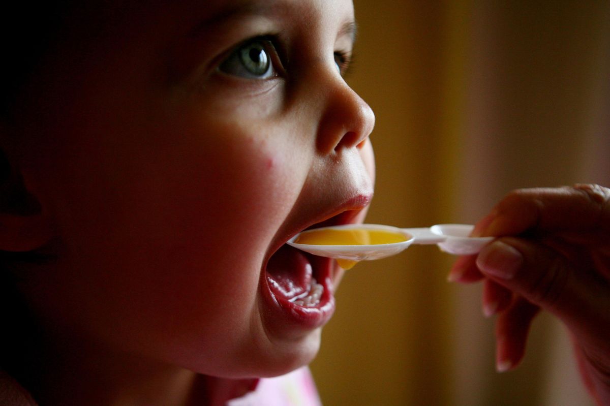 kid taking medicine