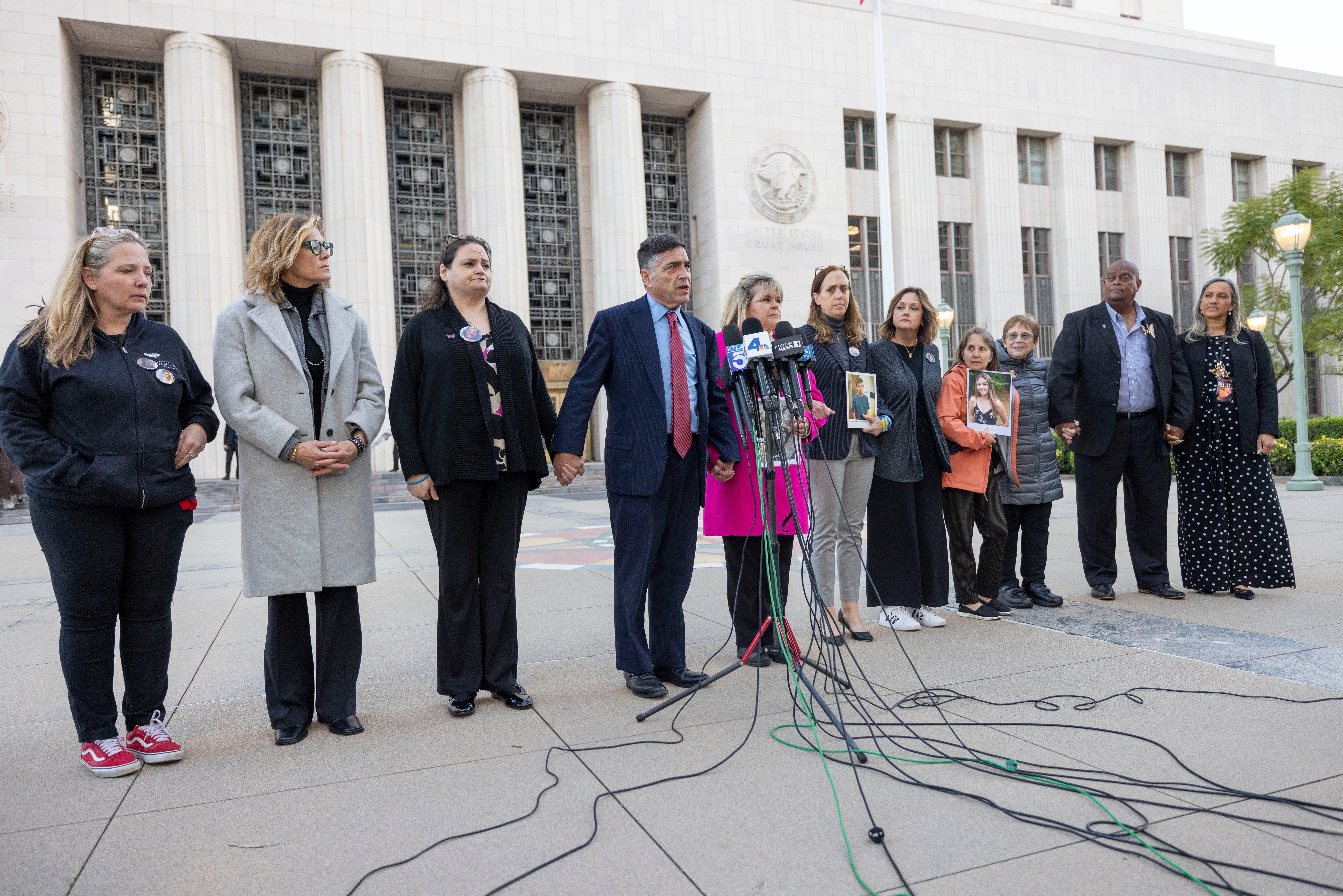 Families stand outside the trial against Meta, which it ultimately lost, accusing the company of building social networks that were deliberately addictive and caused psychological harm to children