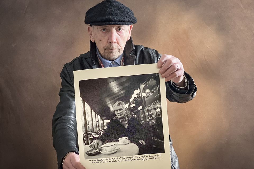 Photographer John Minihan with a print of his famous photo of Samuel Beckett. Photo: SH Bean