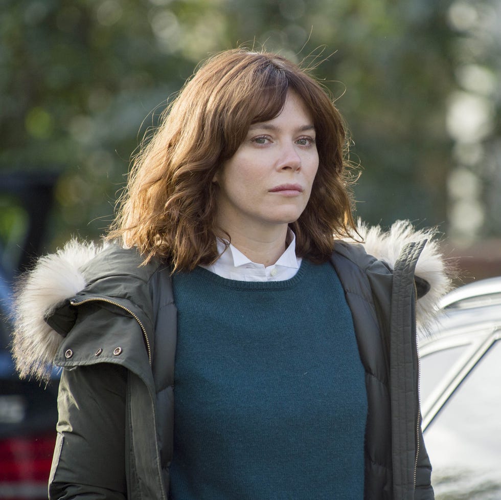 person dressed in casual attire standing near a car