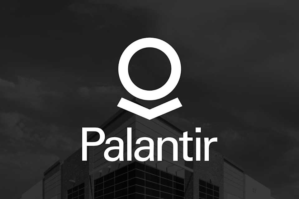 Palantir logo in front of backdrop with corporate building in background.