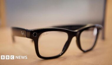 A set of black Meta Ray-Ban smart glasses on a table.