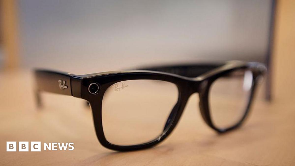 A set of black Meta Ray-Ban smart glasses on a table.