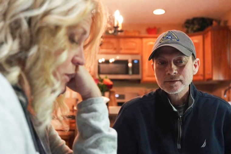 Rebecca Tennant, left, and Eric Tennant sit at their kitchen table