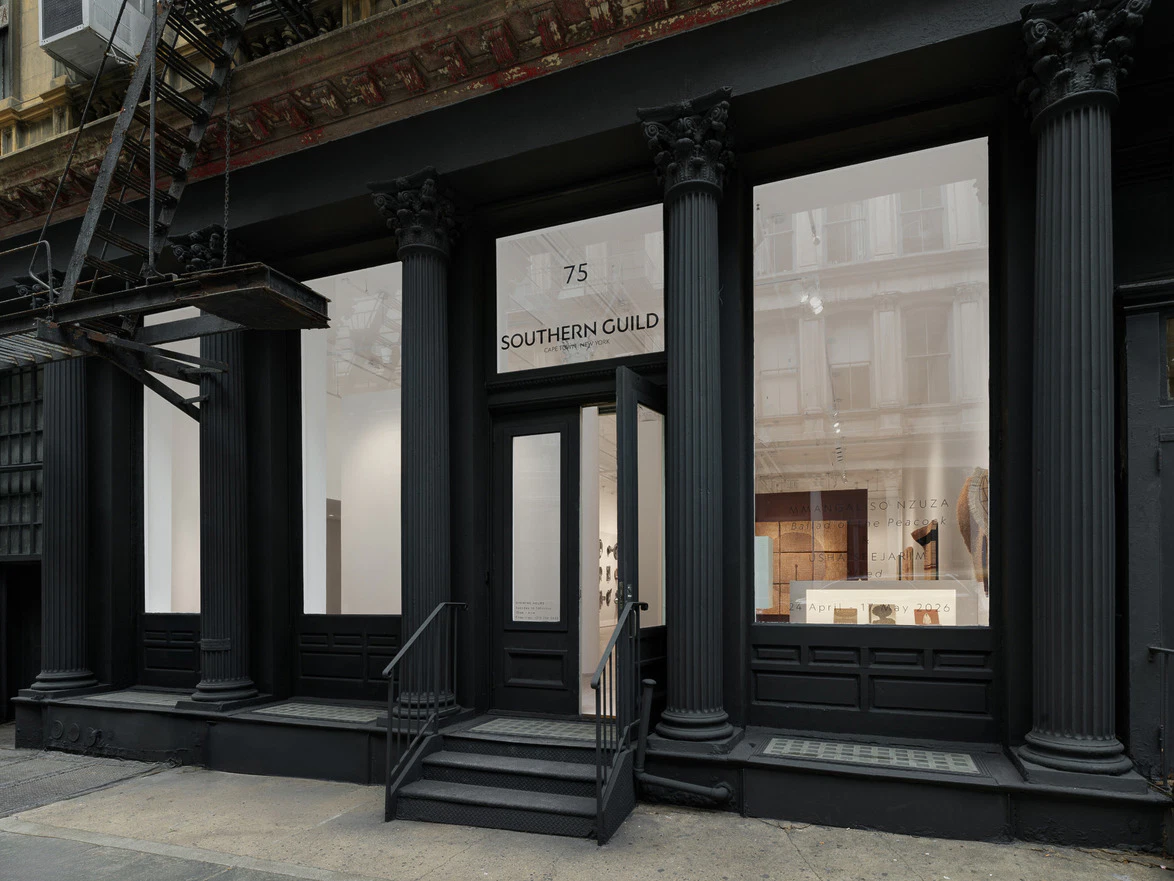 Exterior of Southern Guild gallery with black columns and large windows displaying art pieces.