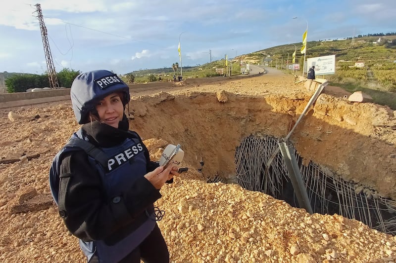 Amal Khalil, who worked for Al-Akhbar, reporting near a destroyed bridge last month. She was killed on Wednesday. Photograph by Mohammed Zaatari/Associated Press