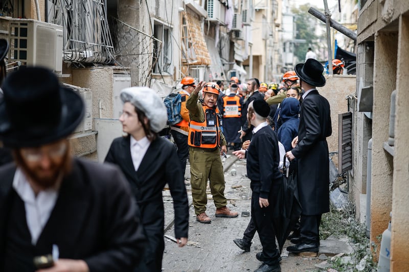 A first responder gestures at the scene of an impact following an Iranian strike over Bnei Brak in central Israel on Wednesday. The Israeli military said its air defences responded to a missile attack from Iran, with warning sirens activated across central Israel. Photograph: Marco Longari/AFP via Getty Images