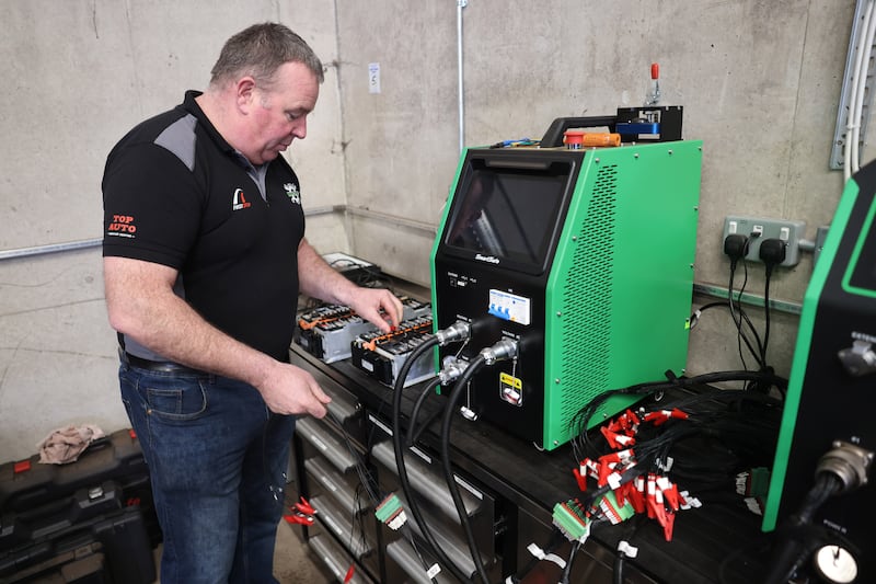 Service Stop's David Corbally with some of the EV battery repair equipment in the garage in Westpalstown, Oldtown, Co Dublin. Photograph: Dara Mac Dónaill
