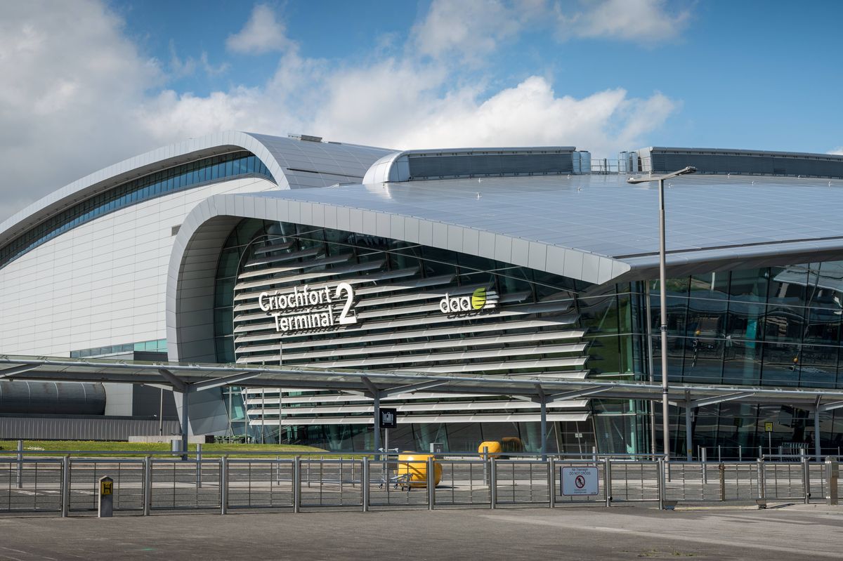 Panoramic of the exterior sign on side of the building at Terminal 2 at Dublin Airport, Ireland, on a sunny day with broken clouds