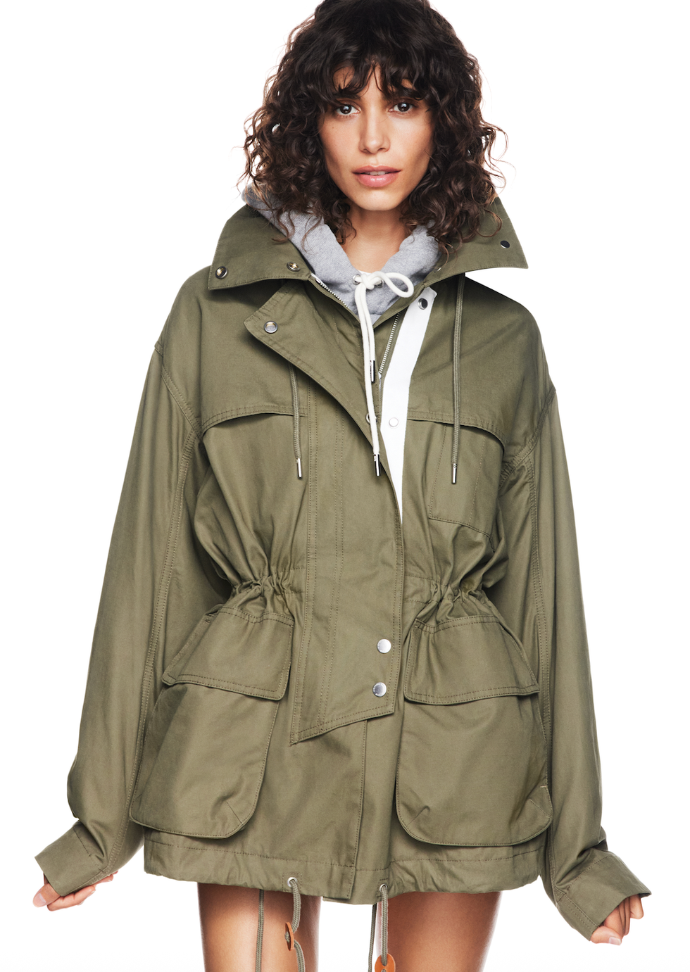 Oversized olive green jacket with drawstrings and pockets.
