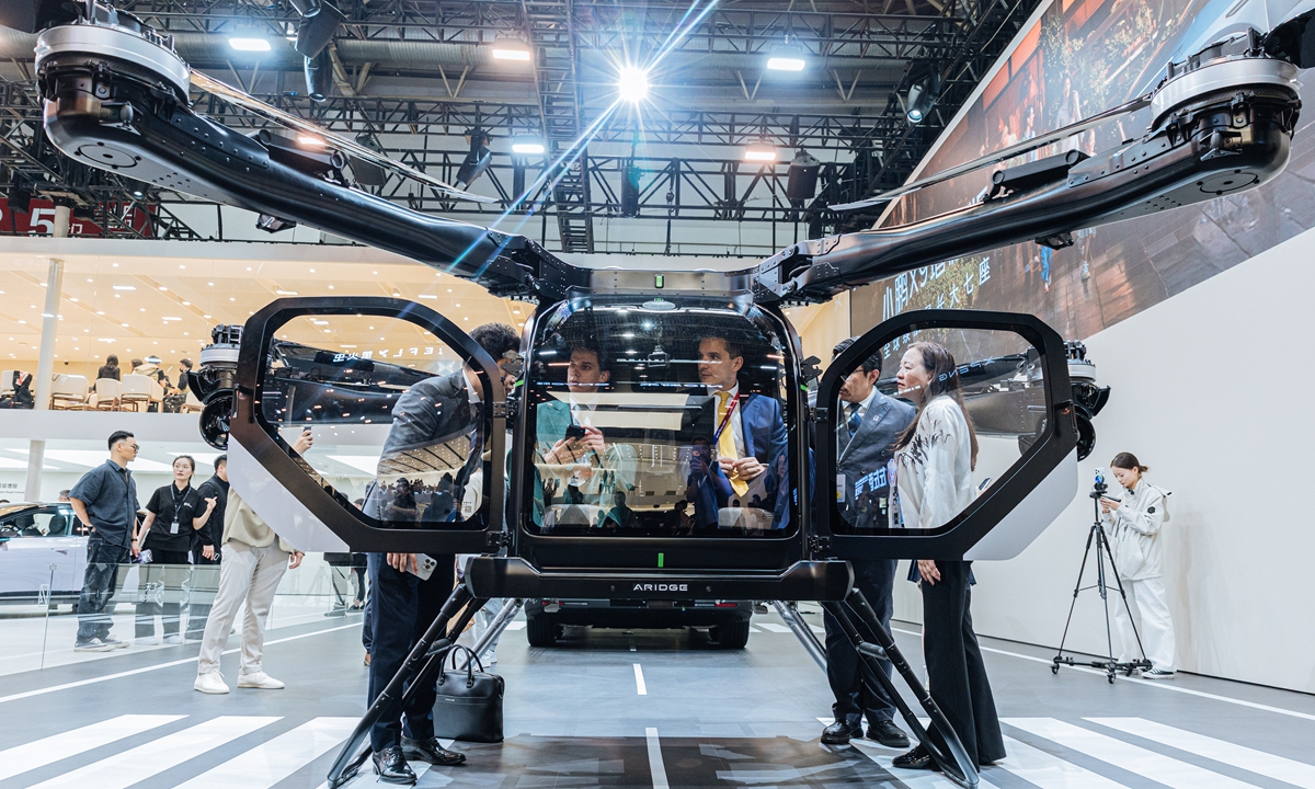 Foreign visitors try out the a split-type modular flying car developed by Chinese electric vehicle maker XPENG, at the 2026 Beijing Auto Show on April 24, 2026. Photo: Li Hao/GT