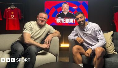 Wayne Rooney and Bruno Fernandes battle for the ball