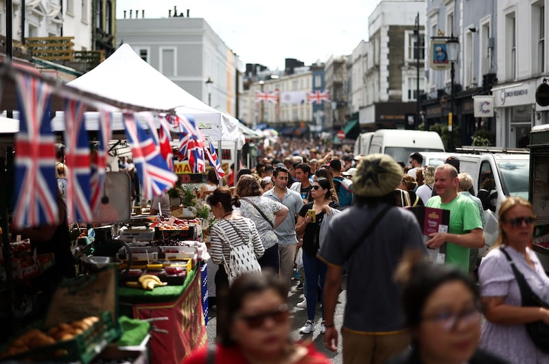 Throngs walk past stalls at Portobello Road Market in west London. Photograph: Henry Nicholls/AFP/Getty