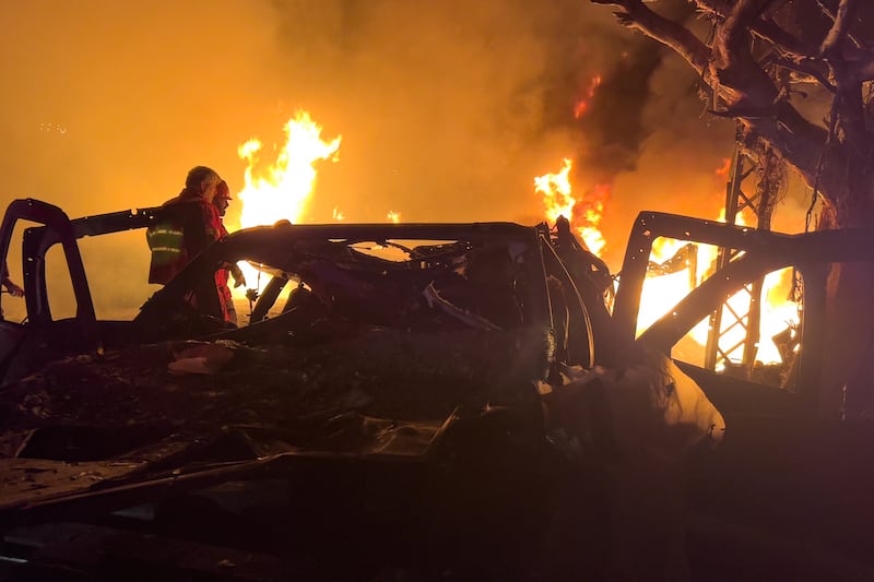 Rescue workers check the site of Israeli airstrikes, in Beirut, Lebanon, early on Wednesday, April 1, 2026. (AP Photo/Hussein Malla)