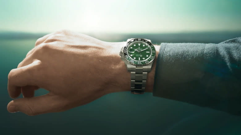 An analog wristwatch on a man's wrist.