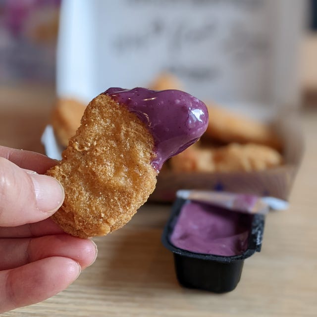Chicken nugget dipped in a purple sauce.