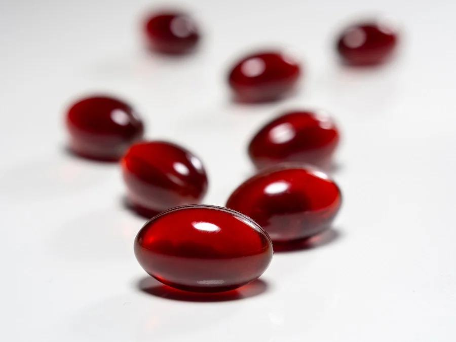 Red omega-3 supplement capsules
