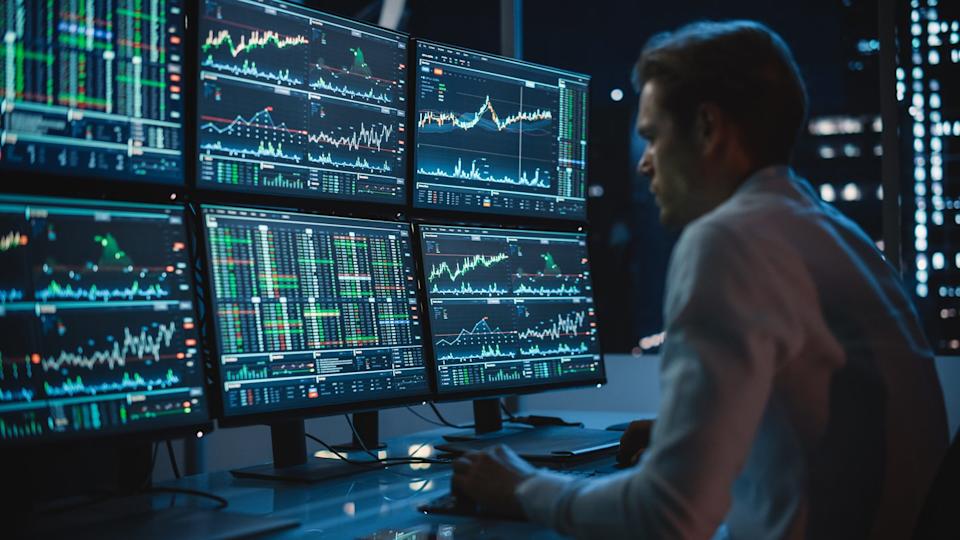 An investor is looking at rising stock charts. 