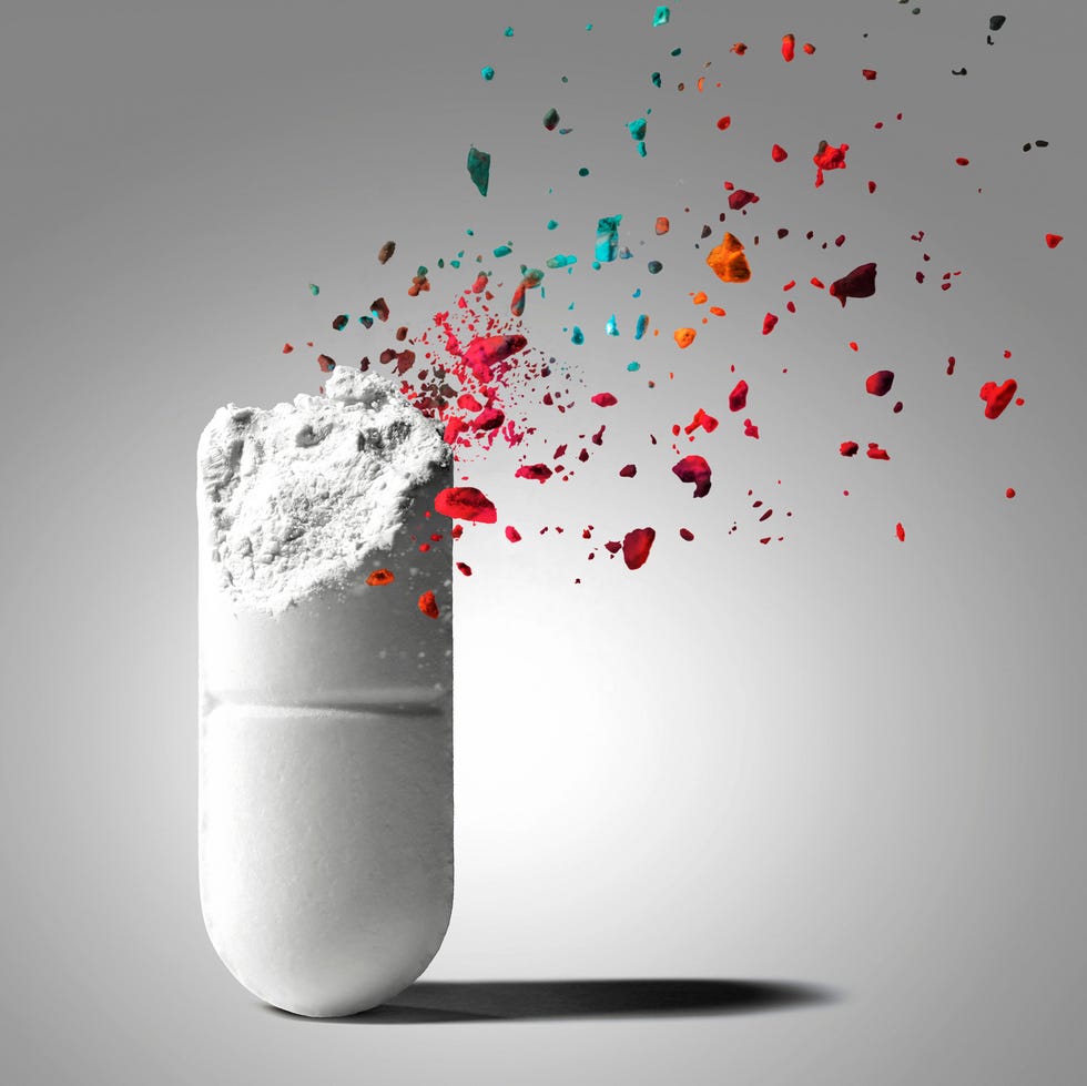 Open capsule with colorful particles dispersing from it. Open capsule with colorful particles dispersing from it.