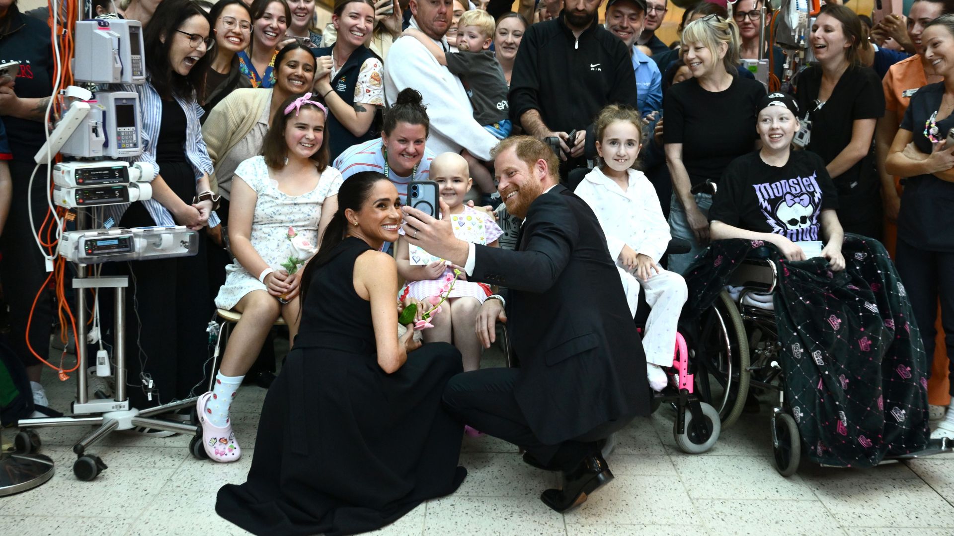 Prince Harry and Meghan Markle take photos with patients during their visit to the Royal Children's Hospital in Melbourne, Australia, 14 April 2026.