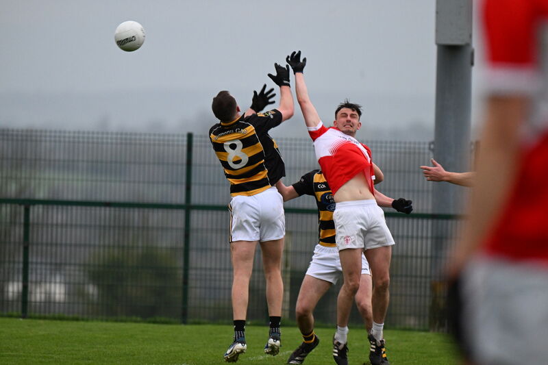  Anthony O’Neill of Avondhu and David Lynch of Seandún challenge in the air for possession. Picture: Larry Cummins