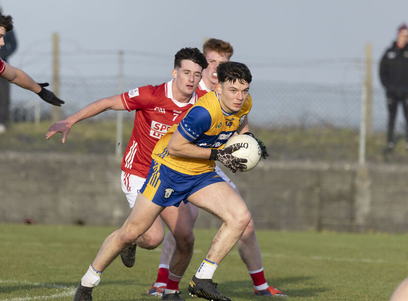 Clare's Daire Culligan and Cork's Odhran Foley in action. Picture: Eamon Ward